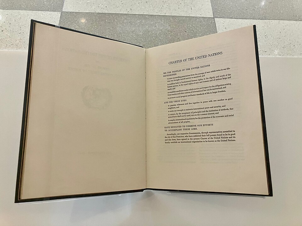 Open book showing a page titled 'Charter of the United Nations'.