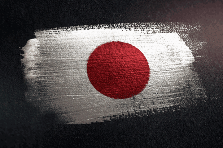 Red disc of the Japanese flag painted on a rough white brushstroke against a dark textured background.